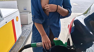 She Is Refueling at the Gas Station, Showing Her Tits and Pussy
