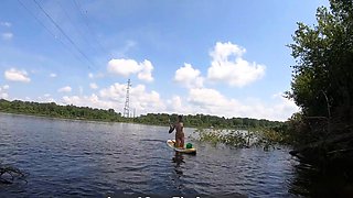 Big-Ass Blonde Rides a SUP Board Naked on a Beach