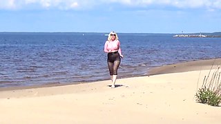 Jokey cougar with nylon caboose and breasts on beach