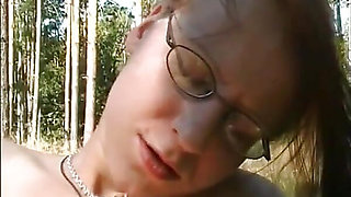 Amazing redhead with small tits masturbates her wet pussy with a dildo outdoors