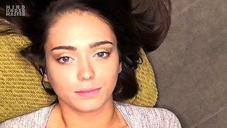 In a kitchen a sexy brunette playing with her big boobs