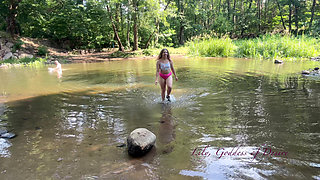 Cute Teen in Costume Playing in the River Like in a Swimming Pool