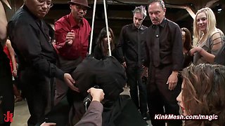 Tied and shrouded in a black sheet