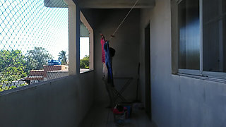 She is naked hanging the laundry out to dry