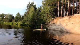Tattooed Babe Strips and Swims on a SUP Board in the Forest