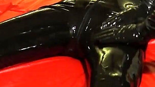 Oil body in latex catsuit