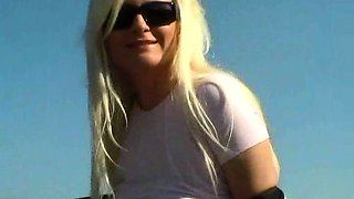 Blonde is flashing her big boobs in the outdoors