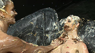 Hot lesbian kiss and lick each other while covered in cream