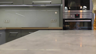 Long hair long legs hot blonde college girl on high heels and a miniskirt which does not cover her ass in the kitchen